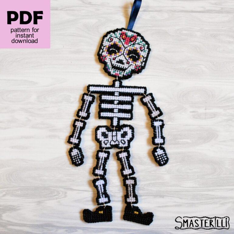 Sugar skull skeleton cross stitch pattern for plastic canvas by Smasterilli, pattern and tutorial with additional skull designs. Digital cross stitch pattern for instant download. Halloween handmade crafts. Plastic Canvas Project #smasterilli #crossstitch #crossstitchpattern #halloweencrossstitch #halloweengift #pumpkincrossstitch #plasticcanvas #sugarskull